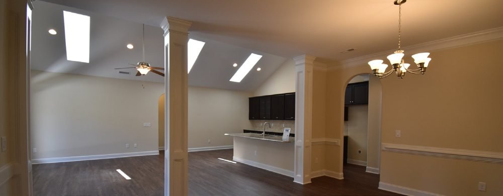 Skylights over a covered porch keep the room behind it bright