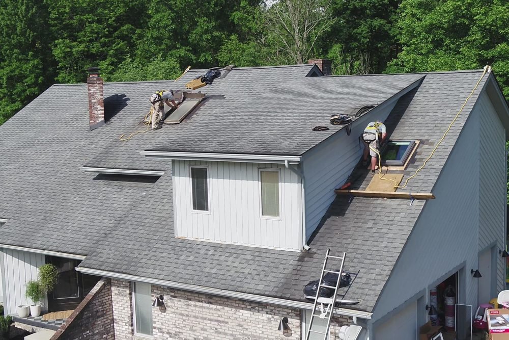 Installing a new skylight with integrated flashing during a reroof