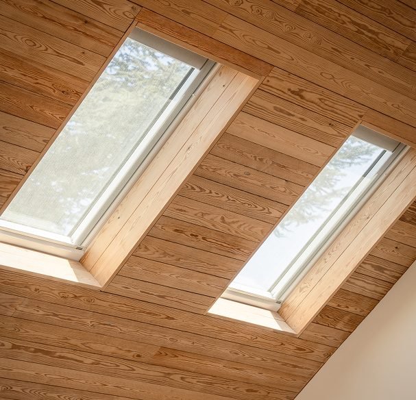 Two fresh air skylights in a wood-plank ceiling